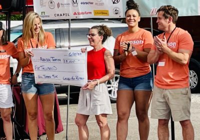 The club presented a $5,000 check to the Robinson Theater Community Arts Center at their In the Sun Again Community Block Party.