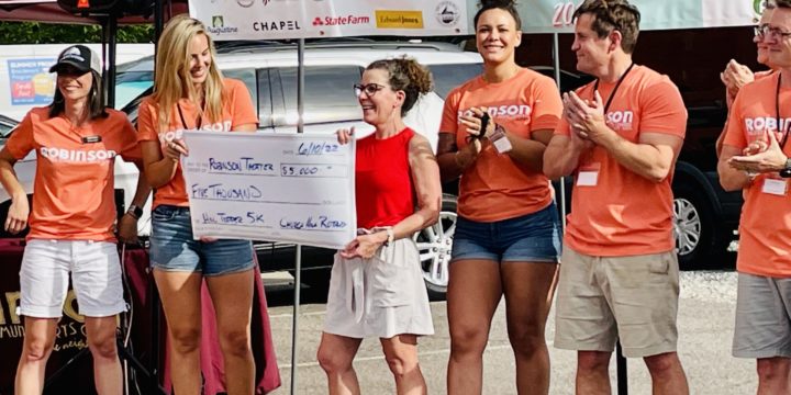 The club presented a $5,000 check to the Robinson Theater Community Arts Center at their In the Sun Again Community Block Party.